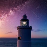 A lighthouse against the stars